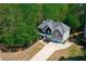 Exterior features stone accents, a two car garage, and professional landscaping at 1326 Benbrooke Nw Ln, Acworth, GA 30101