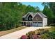 Traditional home featuring stone accents, mature landscaping, and a welcoming front porch at 1326 Benbrooke Nw Ln, Acworth, GA 30101