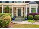 Inviting front entry with stone facade, potted plants, and covered porch at 1326 Benbrooke Nw Ln, Acworth, GA 30101
