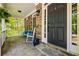 Cozy front porch with stone flooring, rocking chairs, and decorative accents at 1326 Benbrooke Nw Ln, Acworth, GA 30101
