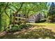 Landscaped front yard with mature trees and shrubs surrounding a stately home at 1326 Benbrooke Nw Ln, Acworth, GA 30101