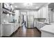 Stylish kitchen with stainless appliances, white cabinets, brick backsplash, and open layout at 1326 Benbrooke Nw Ln, Acworth, GA 30101