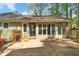 View of the rear of the house with back deck featuring multiple windows and a glass pane door at 1819 Yorkshire Dr, Woodstock, GA 30189