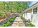Landscaped backyard with lush greenery and tiered retaining wall, adding to the property's charm at 1819 Yorkshire Dr, Woodstock, GA 30189