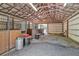 Inside a well-maintained barn featuring multiple stalls and a gravel floor at 1819 Yorkshire Dr, Woodstock, GA 30189
