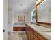 Bathroom features a double sink vanity with granite countertop and soaking tub at 1819 Yorkshire Dr, Woodstock, GA 30189
