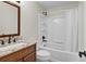 Bathroom featuring a single sink, wood vanity, and a tub with shower at 1819 Yorkshire Dr, Woodstock, GA 30189
