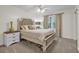 Bright bedroom with a plush bed, neutral tones, and a ceiling fan at 1819 Yorkshire Dr, Woodstock, GA 30189