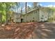Exterior view of the house with back deck, screened porch and lush surrounding trees at 1819 Yorkshire Dr, Woodstock, GA 30189