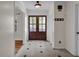 Inviting foyer with a tile floor and a view of the front door and a window at 1819 Yorkshire Dr, Woodstock, GA 30189