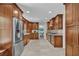 Wide shot of the kitchen showcasing stainless steel appliances, tile floors and granite countertops at 1819 Yorkshire Dr, Woodstock, GA 30189