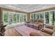 Cozy living room featuring a large sofa and wooded backyard views at 1819 Yorkshire Dr, Woodstock, GA 30189