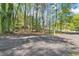 Parking area with dirt ground with green trees surrounding at 1819 Yorkshire Dr, Woodstock, GA 30189