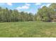 Large grassy horse pasture with a white perimeter fence and trees surrounding at 1819 Yorkshire Dr, Woodstock, GA 30189