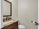 Powder room features a single sink vanity, and toilet at 1819 Yorkshire Dr, Woodstock, GA 30189