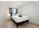 Bedroom with wood floors, a ceiling fan, and a view outside the window at 300 Peachtree Ne St # 21H, Atlanta, GA 30308
