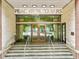 The Peachtree Towers entrance has stone steps and a glass door leading into the building at 300 Peachtree Ne St # 21H, Atlanta, GA 30308