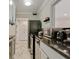 Galley kitchen with appliances, marble floors, and a view into an adjacent room at 300 Peachtree Ne St # 21H, Atlanta, GA 30308