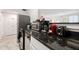 A partial view of the kitchen showcasing black granite countertops and modern appliances at 300 Peachtree Ne St # 21H, Atlanta, GA 30308