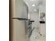 Compact kitchen features stainless steel appliances, white cabinetry, and marble flooring at 300 Peachtree Ne St # 21H, Atlanta, GA 30308