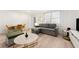 Well-lit living space featuring a convertible sofa, round marble tables, and light-colored flooring at 300 Peachtree Ne St # 21H, Atlanta, GA 30308