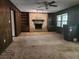 Cozy living room with brick fireplace and built-in shelving at 69 N Hearn Rd, Ellenwood, GA 30294