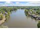 Picturesque aerial view of homes along the lake with lush greenery, showcasing a desirable neighborhood setting at 1330 Badingham Dr, Cumming, GA 30041