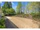 A well-maintained backyard with manicured landscaping and a partially shaded area for outdoor enjoyment at 1330 Badingham Dr, Cumming, GA 30041