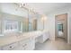Bright bathroom features a double vanity, custom tile, and shower with glass doors at 1330 Badingham Dr, Cumming, GA 30041