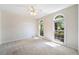 Sunlit bedroom with ceiling fan, two arched windows, and neutral carpet at 1330 Badingham Dr, Cumming, GA 30041