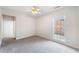 Bedroom with neutral walls, carpet, ceiling fan, and window for ample natural light at 1330 Badingham Dr, Cumming, GA 30041