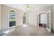 Bedroom with ceiling fan, carpet, arched windows, and French doors at 1330 Badingham Dr, Cumming, GA 30041
