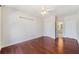 Bright bedroom featuring hardwood floors, ceiling fan, and doorways that lead to a bathroom and other rooms at 1330 Badingham Dr, Cumming, GA 30041
