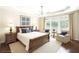 Comfortable bedroom with tray ceiling, large window, and elegant furnishings at 1330 Badingham Dr, Cumming, GA 30041