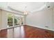 Spacious bedroom with tray ceiling, fan, hardwood floors, and a large window for ample natural light at 1330 Badingham Dr, Cumming, GA 30041