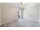 Bright bedroom showcases neutral walls, carpet, ceiling fan and window at 1330 Badingham Dr, Cumming, GA 30041