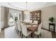 Staged dining room featuring a decorative chandelier and a large dining table at 1330 Badingham Dr, Cumming, GA 30041