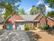 Beautiful brick home with two-car garage, complemented by a well-manicured lawn and mature trees in a lovely setting at 1330 Badingham Dr, Cumming, GA 30041