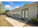 Back of the home with multiple windows and a concrete patio, surrounded by a well-manicured lawn at 1330 Badingham Dr, Cumming, GA 30041