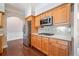 Bright kitchen features wooden cabinetry, stainless steel appliances, and tile backsplash at 1330 Badingham Dr, Cumming, GA 30041