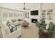 Staged living room with fireplace, built-in bookshelves, and comfortable seating at 1330 Badingham Dr, Cumming, GA 30041