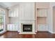 Living room with fireplace and built-in shelving with natural light from a large window at 1330 Badingham Dr, Cumming, GA 30041