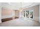 Open-concept space with a chandelier, large windows, and neutral carpet at 1330 Badingham Dr, Cumming, GA 30041