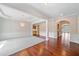 Spacious living area featuring hardwood floors, elegant chandelier and detailed trim at 1330 Badingham Dr, Cumming, GA 30041