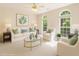 Cozy living room with a neutral palette, comfortable seating, and natural light from arched windows at 1330 Badingham Dr, Cumming, GA 30041