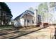 Large grassy backyard featuring a two-story home with a spacious deck perfect for outdoor relaxation at 4557 Waldens Farm Ct, Powder Springs, GA 30127