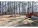 Lawn features a large wooden deck perfect for outdoor entertaining in a private backyard at 4557 Waldens Farm Ct, Powder Springs, GA 30127