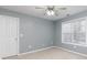 Bedroom with plush carpeting, a ceiling fan, and a window with natural lighting at 4557 Waldens Farm Ct, Powder Springs, GA 30127