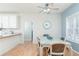 Bright dining area featuring a glass table, wood floors, and a ceiling fan at 4557 Waldens Farm Ct, Powder Springs, GA 30127