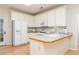 White kitchen featuring lots of cabinet space, modern appliances, and a breakfast bar at 4557 Waldens Farm Ct, Powder Springs, GA 30127